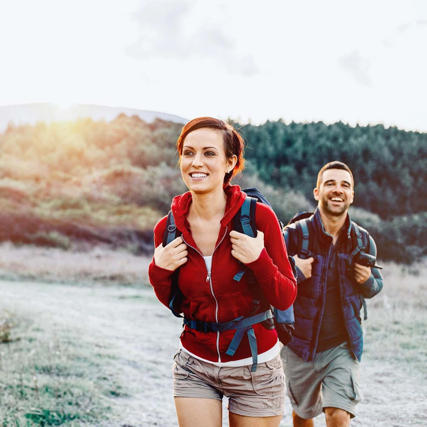 Woman and man hiking in autumn