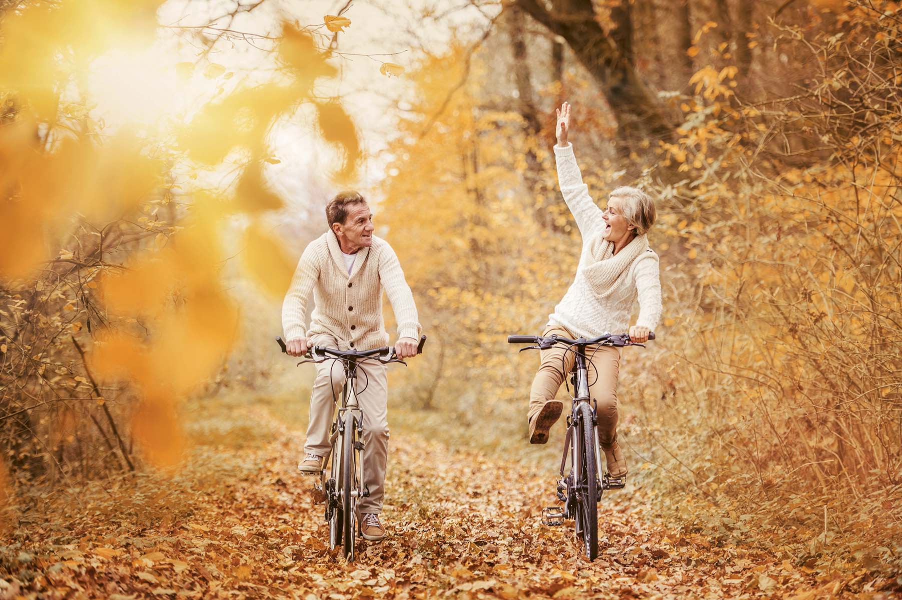 Mann und Frau beim Radfahren im herbstlichen Wald